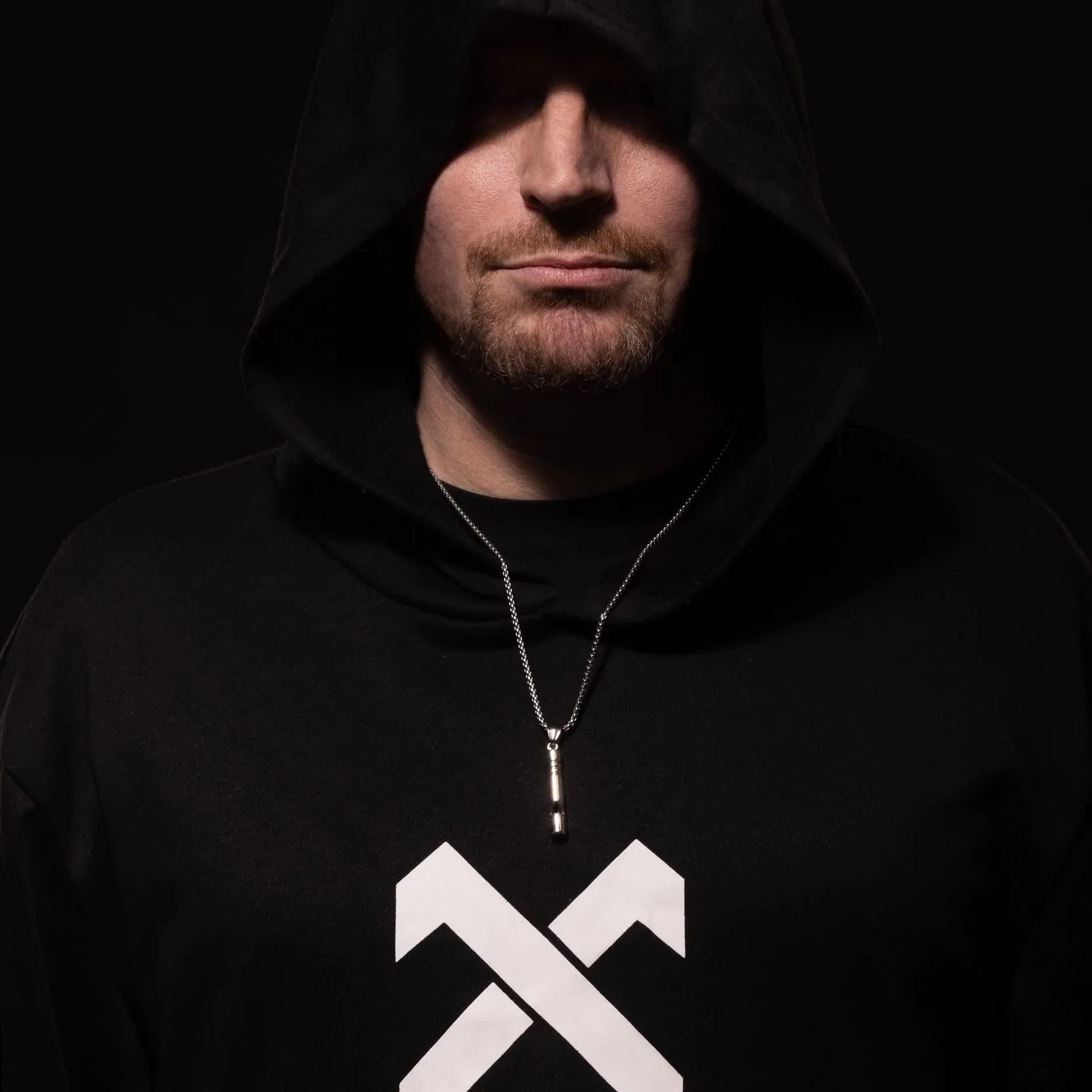 Close portrait of Carl Nicholson in a black hoodie